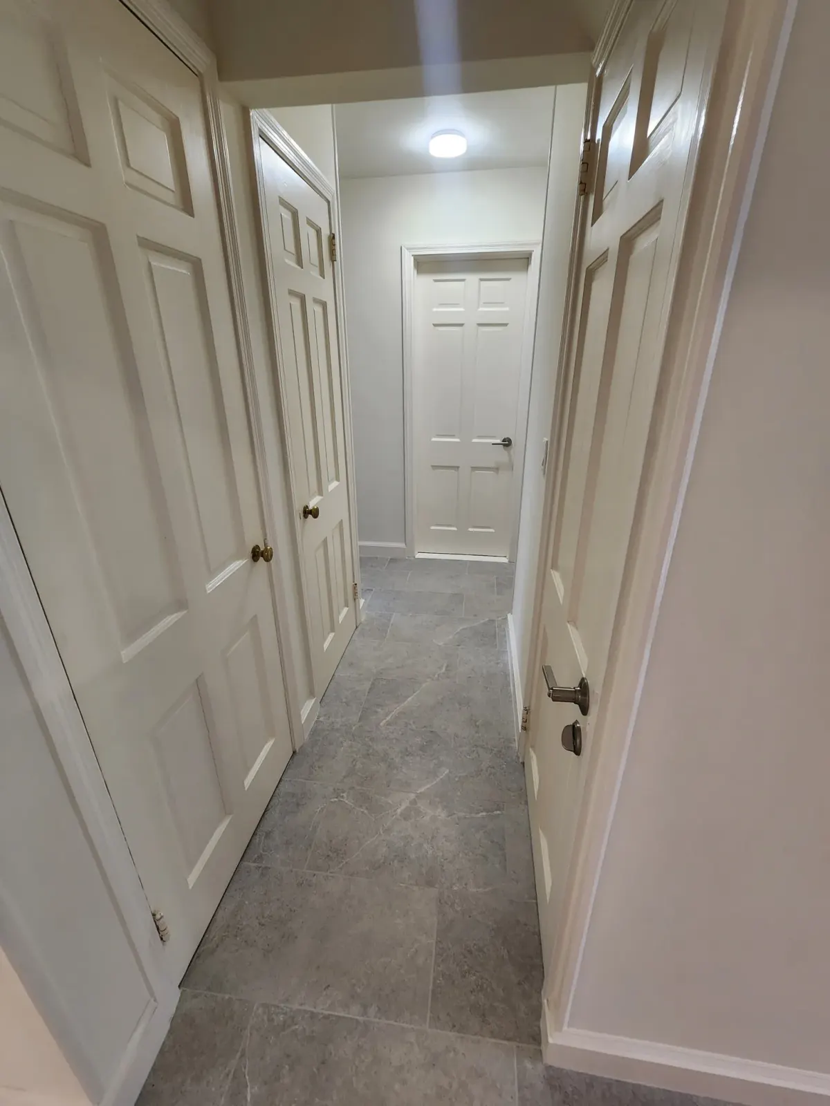 Interior hallway with new large-format stone-look floor tile in a Scarsdale, NY renovation
