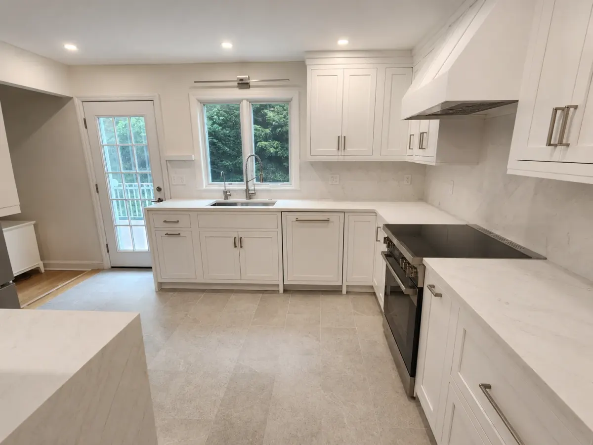 Kitchen peninsula with waterfall countertop edge and induction cooktop in a Scarsdale, NY renovation